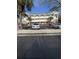 Condominium exterior with ample parking, palm trees, and a bright, sunny sky at 4155 Hibiscus Dr. # 103, Little River, SC 29566