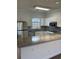 Well-lit kitchen featuring stainless steel appliances, granite countertops, and white cabinetry at 4155 Hibiscus Dr. # 103, Little River, SC 29566