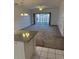 Spacious living room featuring neutral carpet, sliding glass doors to a screened in porch, and modern lighting at 4155 Hibiscus Dr. # 103, Little River, SC 29566