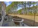 View of the backyard with mature trees and outdoor seating at 437 Colonial Trace Dr. # 2C, Longs, SC 29568