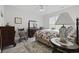 Serene bedroom with a ceiling fan, large dresser, rocking chair, and comfortable bedding at 437 Colonial Trace Dr. # 2C, Longs, SC 29568