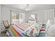 Bedroom with colorful striped bedspread, ceiling fan, and sliding glass door to the outside at 437 Colonial Trace Dr. # 2C, Longs, SC 29568