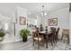 Elegant dining room with a dark wood table, stylish chairs, and ample natural light at 437 Colonial Trace Dr. # 2C, Longs, SC 29568