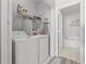 Well-equipped laundry room with modern washer and dryer next to a bathroom at 437 Colonial Trace Dr. # 2C, Longs, SC 29568