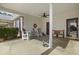 Inviting covered porch with comfortable seating and a ceiling fan at 437 Colonial Trace Dr. # 2C, Longs, SC 29568