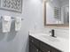 Updated bathroom features a dark vanity with modern faucet and neutral decor at 4420 Eastport Blvd. # M12, Little River, SC 29566