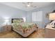 Bright bedroom featuring a queen size bed, side tables with lamps, and hard wood floors at 4420 Eastport Blvd. # M12, Little River, SC 29566