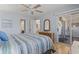 Light filled bedroom with ceiling fan has porch access and a peek at the kitchen at 4420 Eastport Blvd. # M12, Little River, SC 29566