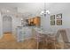 Cozy dining area with glass-top table, seating for four, and stylish chandelier at 4420 Eastport Blvd. # M12, Little River, SC 29566