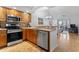 Open-concept kitchen with stainless steel appliances, breakfast bar, and view into the living area at 4420 Eastport Blvd. # M12, Little River, SC 29566