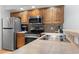 Clean kitchen featuring stainless steel appliances, light wood cabinets, and tiled backsplash at 4420 Eastport Blvd. # M12, Little River, SC 29566
