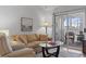 Cozy living room boasts a comfortable seating area and direct porch access at 4420 Eastport Blvd. # M12, Little River, SC 29566