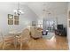 Comfortable living room with vaulted ceiling, ceiling fan, slider to porch, and neutral furniture at 4420 Eastport Blvd. # M12, Little River, SC 29566