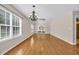 Bright living room with hardwood floors, large windows, and a chandelier at 46 Pembroke Ln. # 46, Pawleys Island, SC 29585