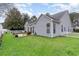 Home's exterior featuring a well-manicured lawn, patio area, and partial white picket fence at 481 Morning Glory Ct., Myrtle Beach, SC 29579
