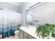Bright bathroom featuring gray vanity with a white countertop, sink and decorative greenery at 481 Morning Glory Ct., Myrtle Beach, SC 29579