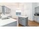 Charming kitchen featuring gray cabinets, an island, modern countertops, and hardwood floors at 481 Morning Glory Ct., Myrtle Beach, SC 29579