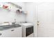 Laundry room with modern white washer and dryer and wire shelving at 481 Morning Glory Ct., Myrtle Beach, SC 29579