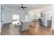 Bright open-concept living area with hardwood floors, a ceiling fan, and views of the kitchen at 481 Morning Glory Ct., Myrtle Beach, SC 29579