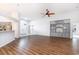Bright and airy living room featuring hardwood floors, a ceiling fan, and built-in shelving at 481 Morning Glory Ct., Myrtle Beach, SC 29579