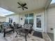 Inviting covered back porch with comfortable seating, ceiling fan, and views of the backyard at 5318 Tremiti Ln., Myrtle Beach, SC 29579