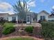 Backyard featuring a screened porch, brick patio, lush landscaping, and a mature crape myrtle tree at 5318 Tremiti Ln., Myrtle Beach, SC 29579
