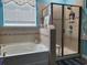 The bathroom features a soaking tub and glass-enclosed shower at 5318 Tremiti Ln., Myrtle Beach, SC 29579