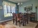 Dining room features a dark wood table, neutral rug, and a decorative window valance at 5318 Tremiti Ln., Myrtle Beach, SC 29579