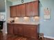 Kitchen features granite countertops, dark wood cabinets, and updated appliances at 5318 Tremiti Ln., Myrtle Beach, SC 29579