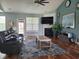 A bright living room includes hardwood floors and a fireplace with views of the backyard at 5318 Tremiti Ln., Myrtle Beach, SC 29579