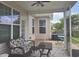 Enjoy the outdoors on this cozy screened-in porch with comfortable seating and a view of the backyard at 5318 Tremiti Ln., Myrtle Beach, SC 29579