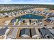 Aerial view of a neighborhood with a lake and community pool at 533 Canborough Lane, Murrells Inlet, SC 29576