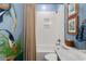 Blue coastal bathroom features tiled shower and modern commode at 533 Canborough Lane, Murrells Inlet, SC 29576