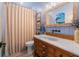 Coastal themed bathroom features unique vanity and mirror, with blue tones and beadboard at 533 Canborough Lane, Murrells Inlet, SC 29576