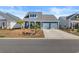 Charming blue home with a two-car garage and a manicured front yard at 533 Canborough Lane, Murrells Inlet, SC 29576