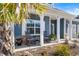 Inviting front porch with rocking chairs, stone accents, and potted plants at 533 Canborough Lane, Murrells Inlet, SC 29576