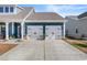 Two car garage with white doors and blue siding at 533 Canborough Lane, Murrells Inlet, SC 29576