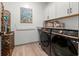 Modern laundry room with updated washer and dryer and decorative shell storage at 533 Canborough Lane, Murrells Inlet, SC 29576