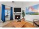 Comfortable living space with a fireplace and TV, complemented by natural light and stylish decor at 533 Canborough Lane, Murrells Inlet, SC 29576