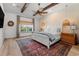 Serene main bedroom features wood beams, decorative lighting, and large windows for a peaceful retreat at 533 Canborough Lane, Murrells Inlet, SC 29576