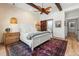 Tranquil main bedroom showcases wood beams, decorative lighting, and a seamless connection to the ensuite bathroom at 533 Canborough Lane, Murrells Inlet, SC 29576
