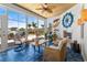 Coastal sunroom with blue tile, ceiling fan, fireplace, and water view at 533 Canborough Lane, Murrells Inlet, SC 29576