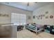 Bright bedroom featuring a large window, themed decor, and neutral-colored walls at 568 Canborough Lane, Murrells Inlet, SC 29576