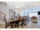 Open-concept dining room with wood floors and a view into the living room, perfect for Gathering gatherings at 568 Canborough Lane, Murrells Inlet, SC 29576