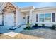 Inviting entrance with a two-car garage, stone accents, and a beautifully landscaped front yard at 568 Canborough Lane, Murrells Inlet, SC 29576