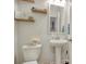 Cozy half bathroom with a pedestal sink, decorative mirror, and stylish decor for guests' convenience at 568 Canborough Lane, Murrells Inlet, SC 29576