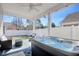 Inviting outdoor hot tub with comfortable patio seating and ceiling fan at 568 Canborough Lane, Murrells Inlet, SC 29576