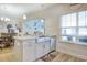 Kitchen island featuring a stainless steel sink and views into the adjacent dining and living areas at 568 Canborough Lane, Murrells Inlet, SC 29576