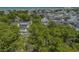 Aerial view of a residential neighborhood with green trees and the ocean in the distance at 6001 - 1308 S Kings Hwy., Myrtle Beach, SC 29575
