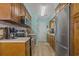 Bright kitchen area featuring a stainless steel refrigerator and wooden cabinets at 6001 - 1308 S Kings Hwy., Myrtle Beach, SC 29575